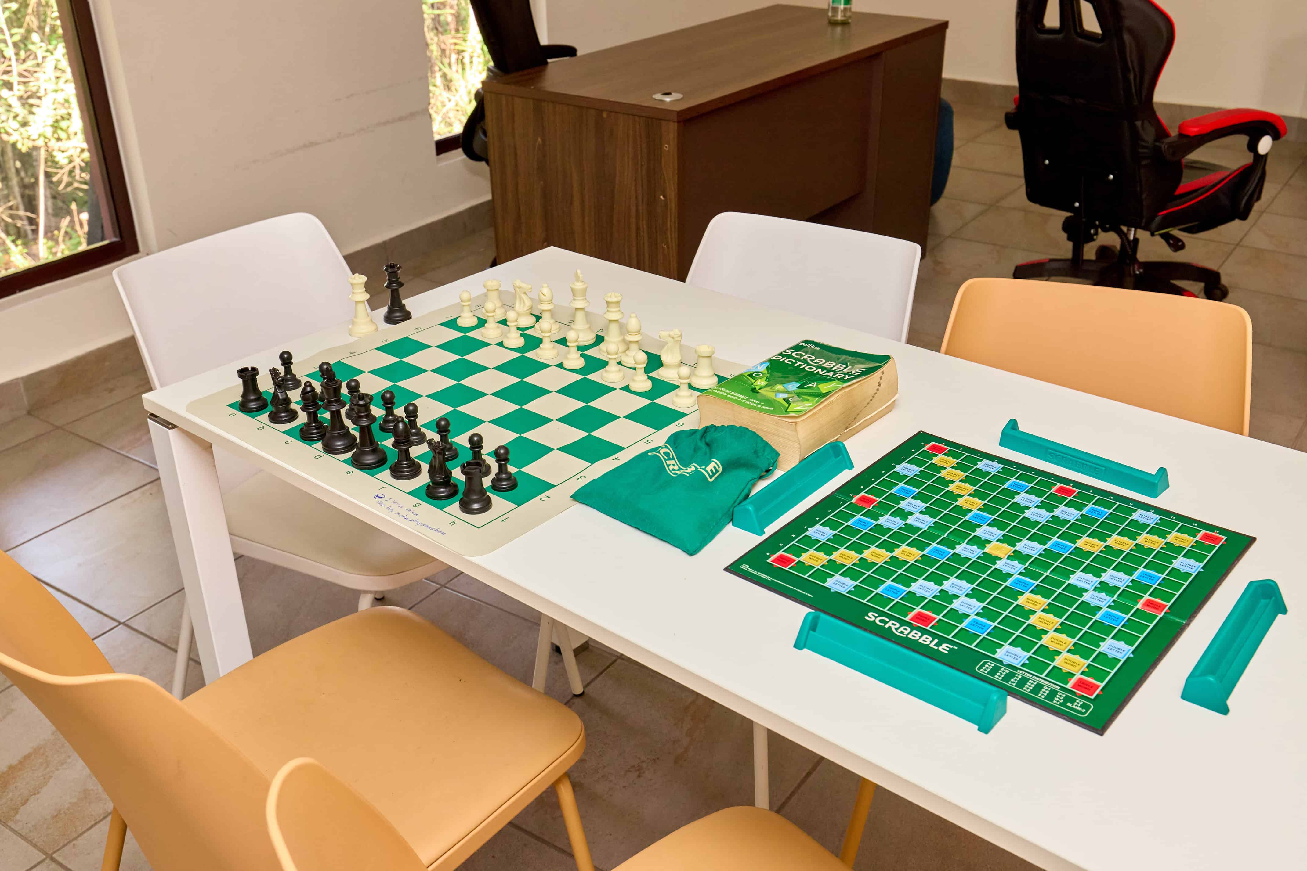 Table set up with chess and Scrabble games for indoor entertainment
