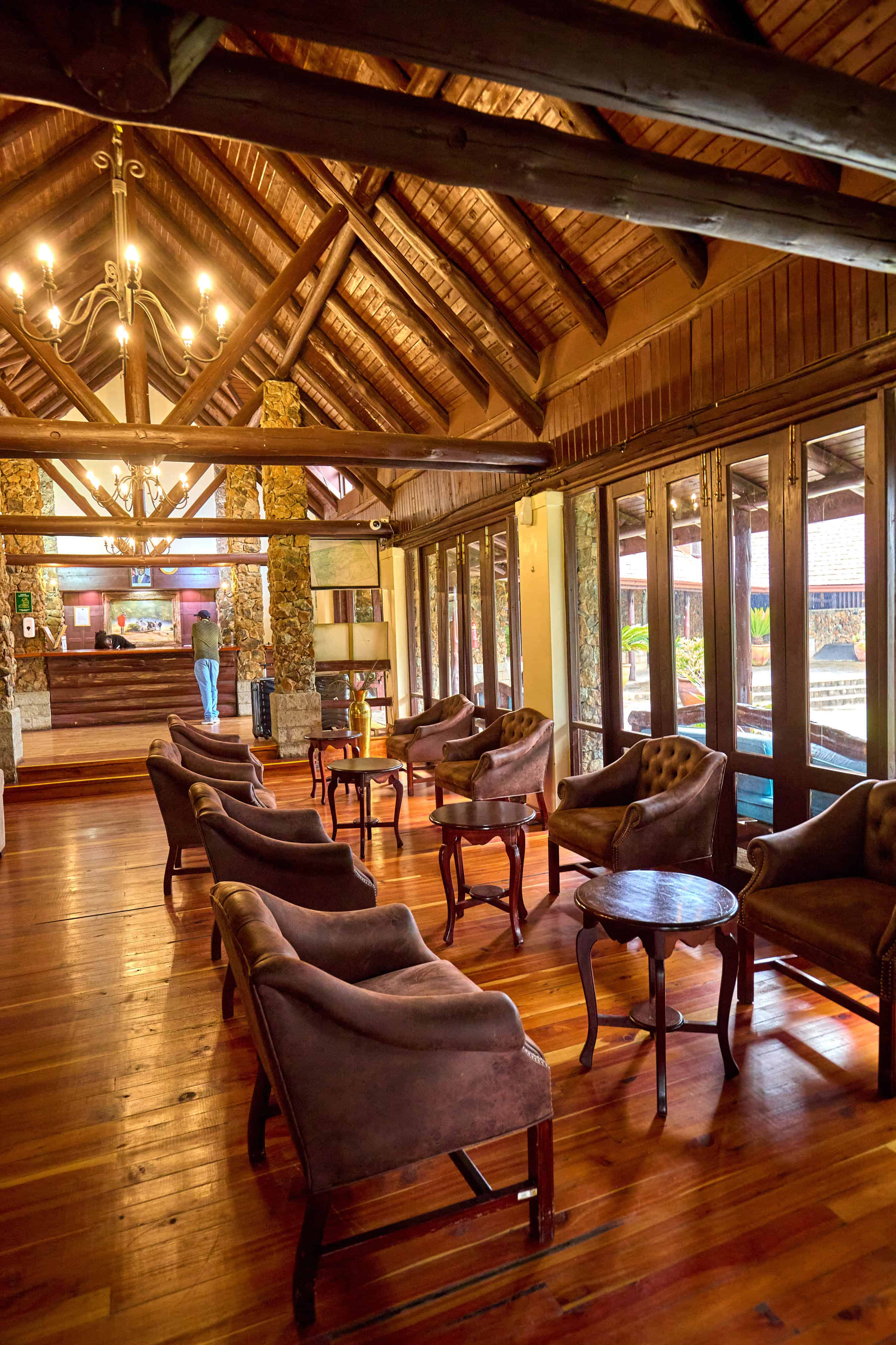 Elegant clubhouse interior with wooden beams and leather armchairs