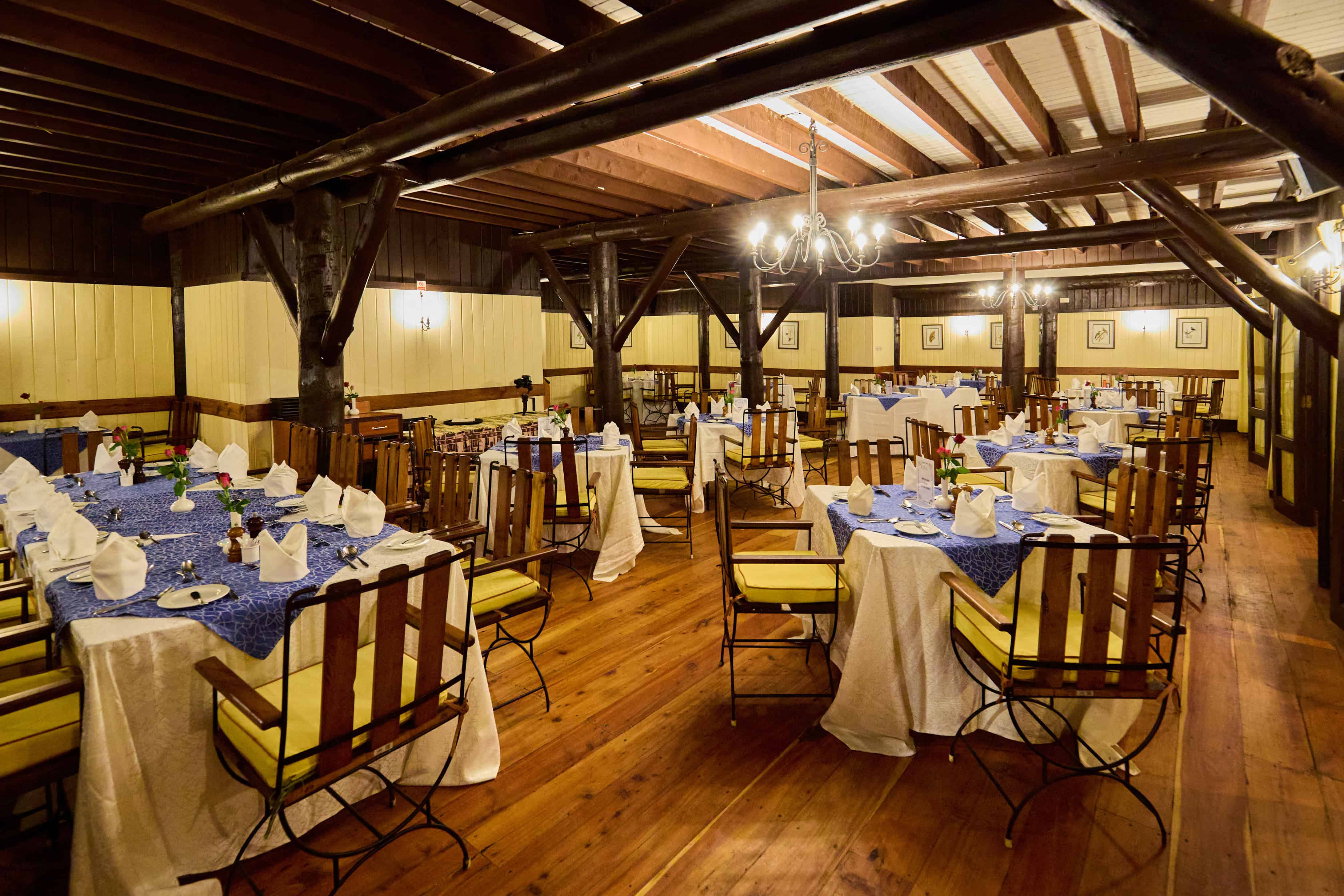 Elegant dining room with exposed beams and formal table settings