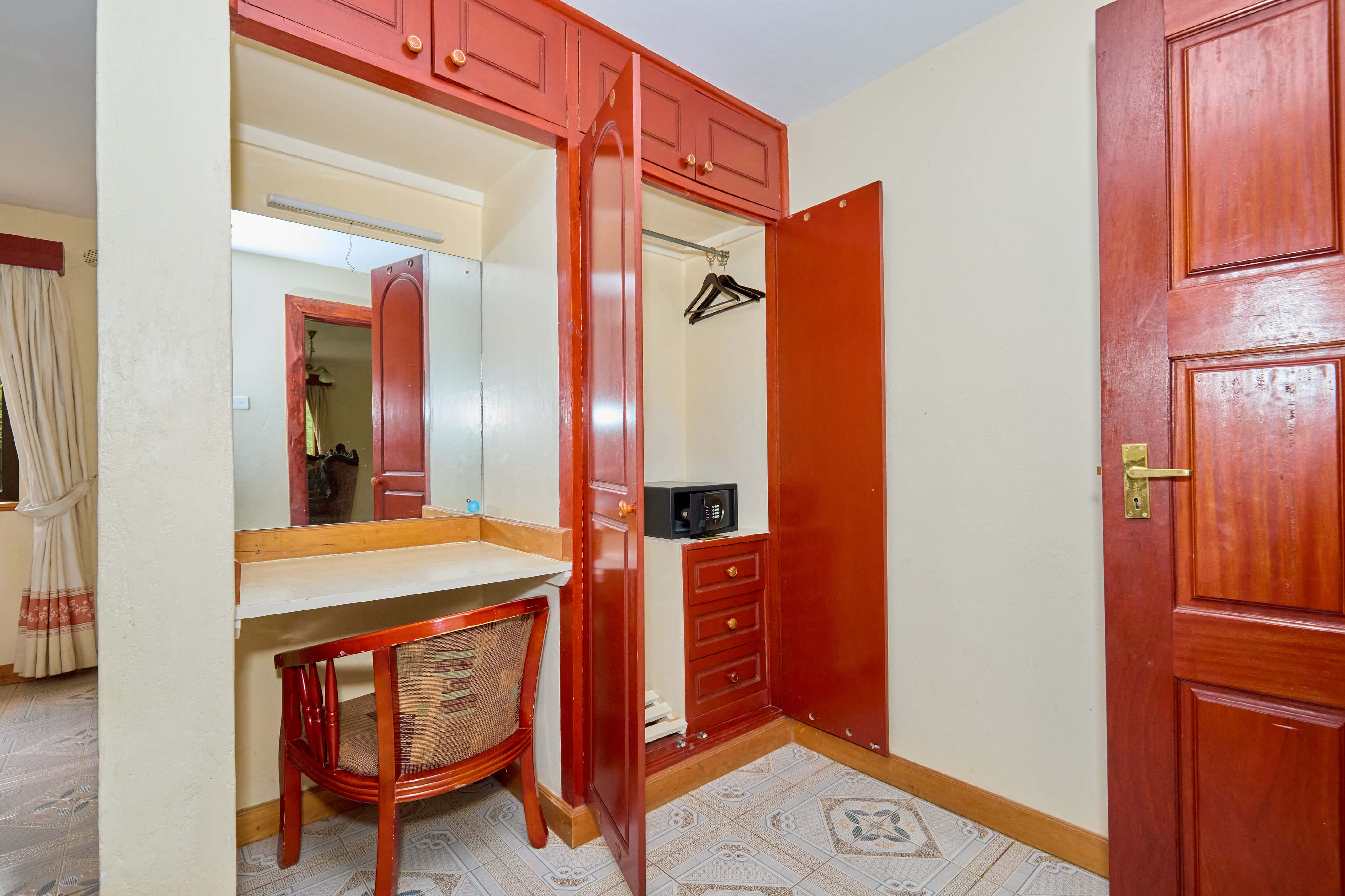 Built-in wardrobes and dressing area with red wood finish