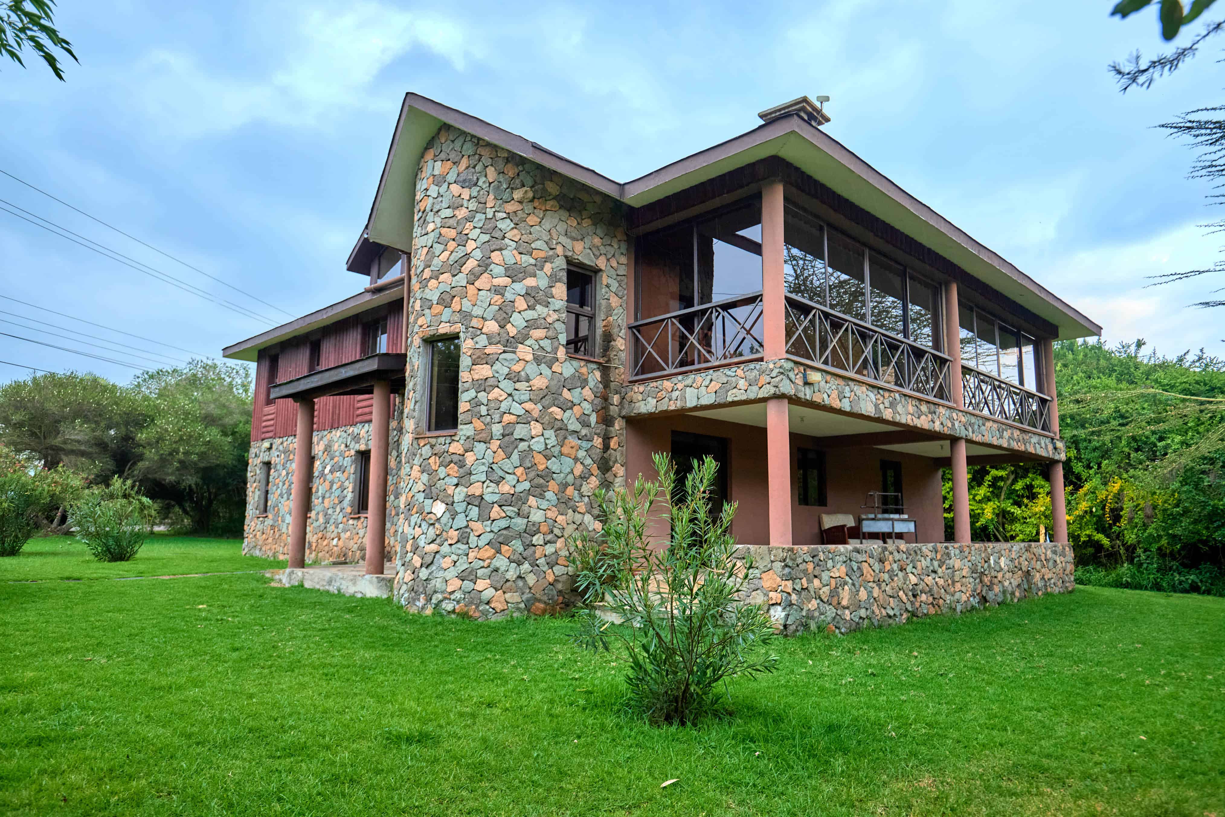 Close-up architectural view highlighting stone work and wooden balcony details