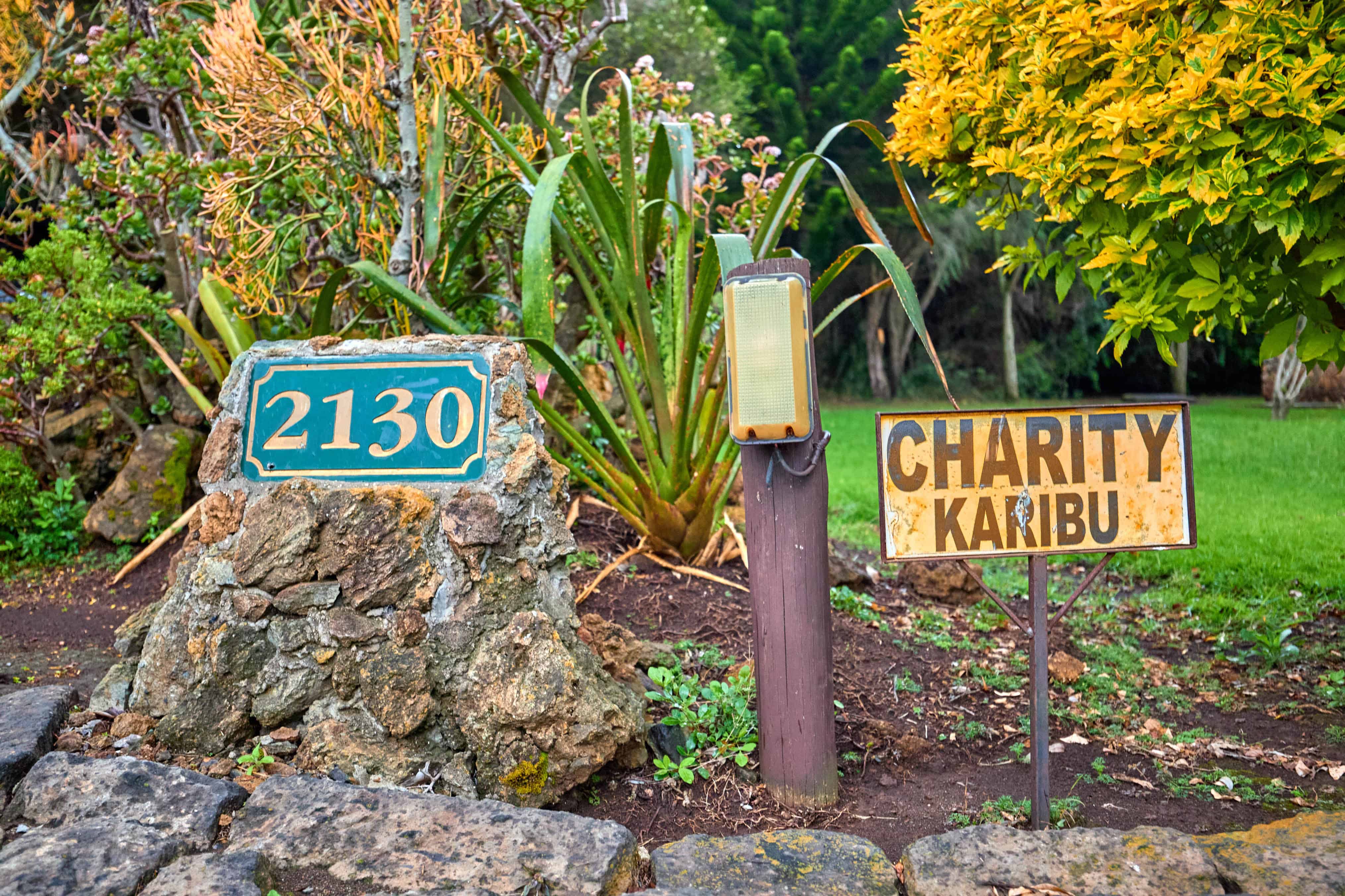 Property entrance with address 2130 and Charity Karibu welcome sign