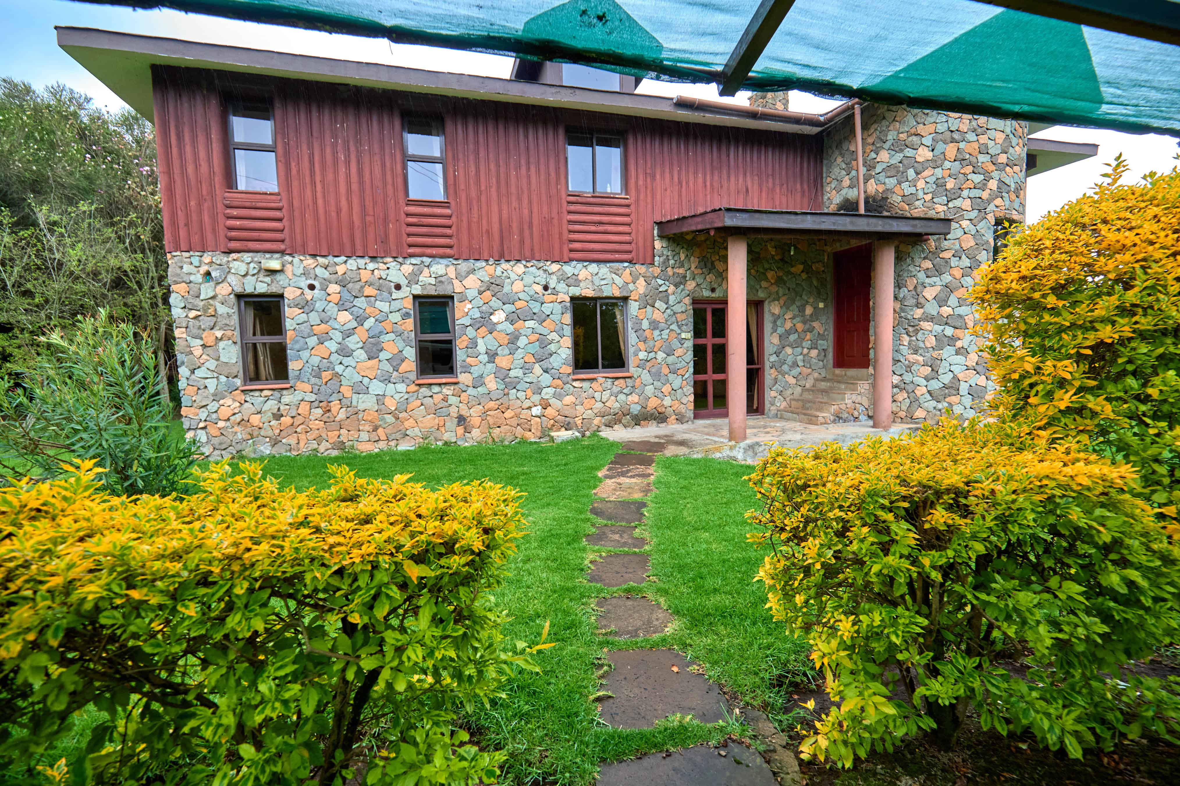 Garden pathway leading to main entrance through landscaped grounds