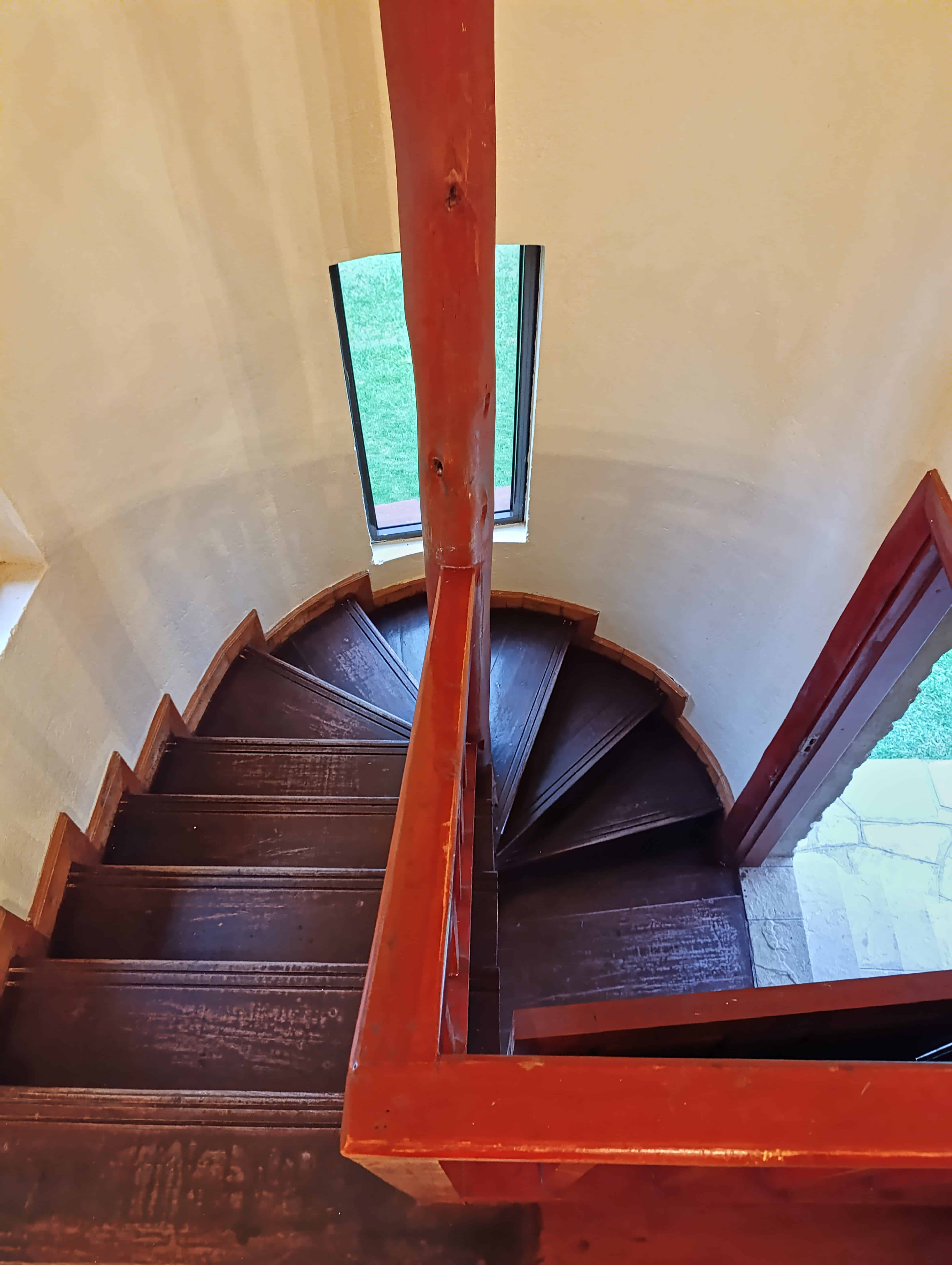 Elegant curved wooden staircase with mahogany finish