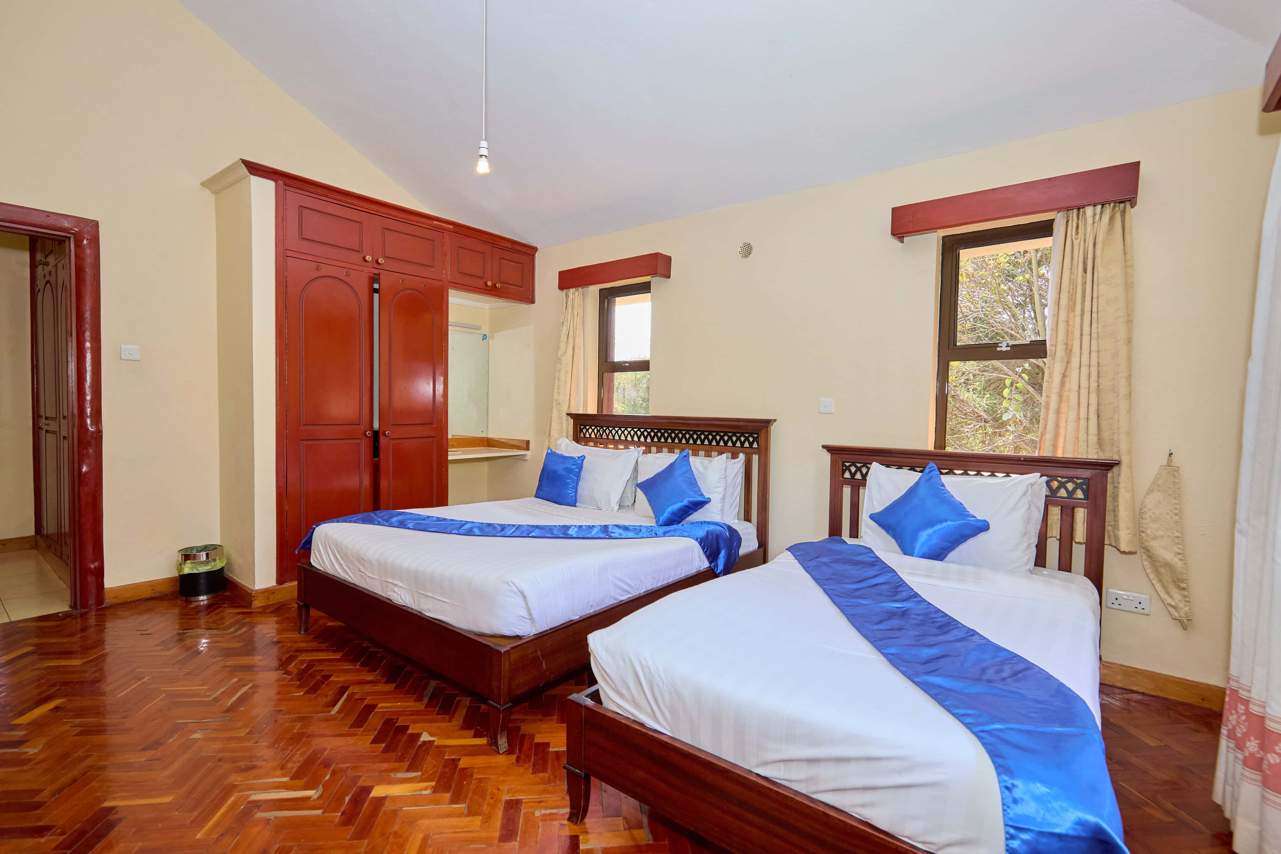 Twin bedroom with blue accents and built-in wardrobes