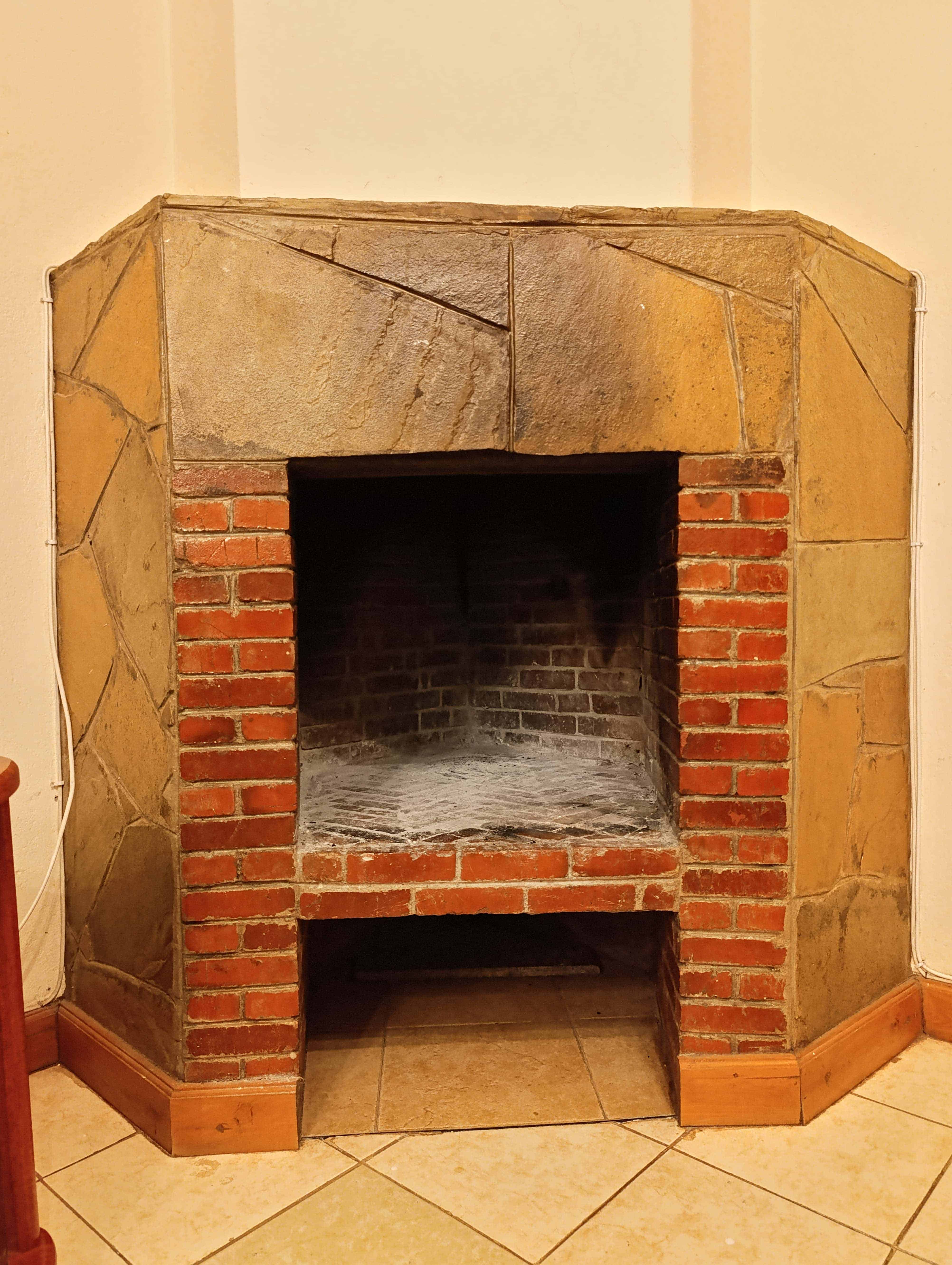 Traditional brick fireplace with rustic stone surround