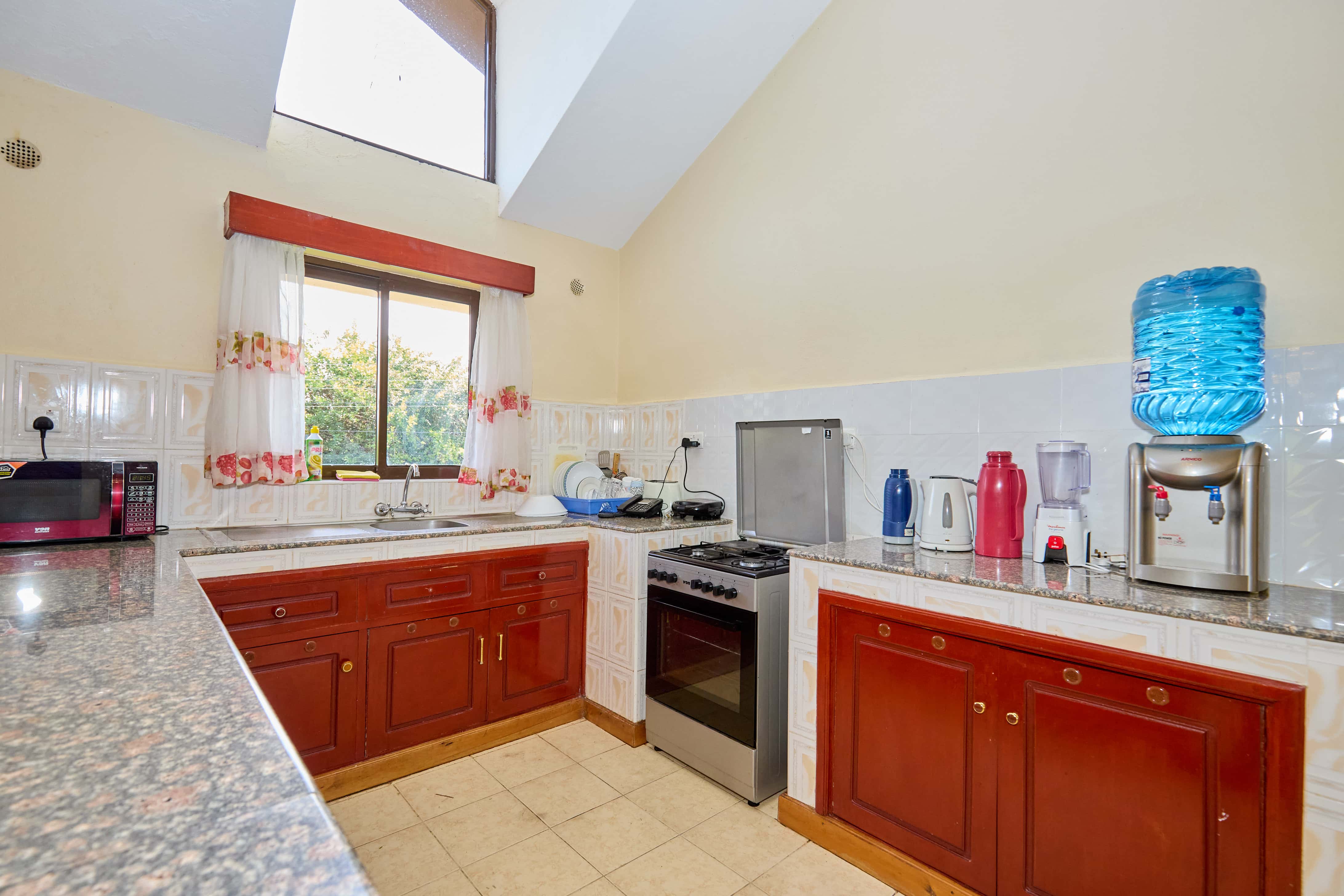 Modern kitchen with red cabinets and granite countertops