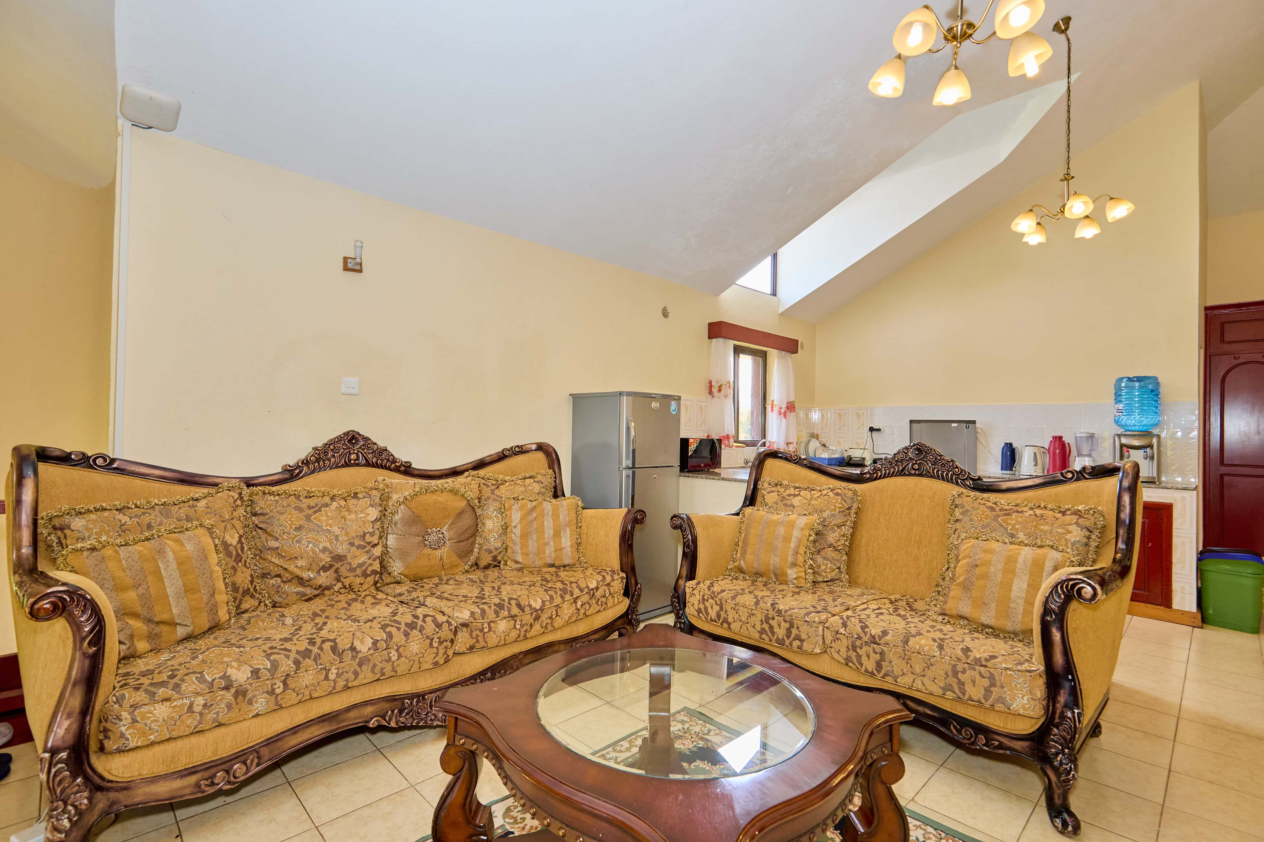 Living room showing ornate furniture and open kitchen connection